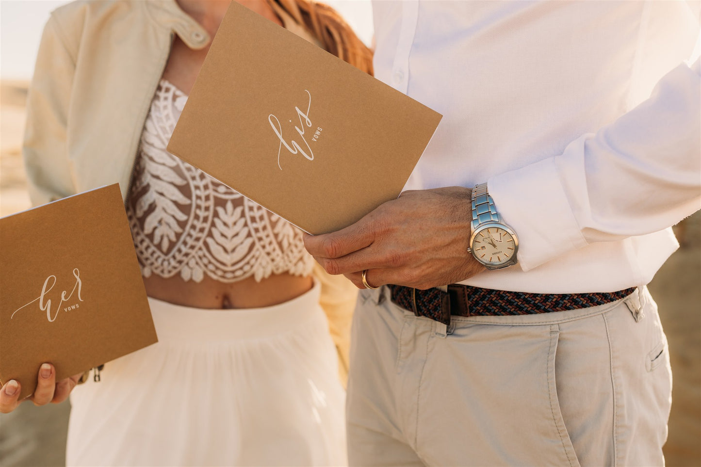 Couple holding wedding vow books | The Paper Gazelle